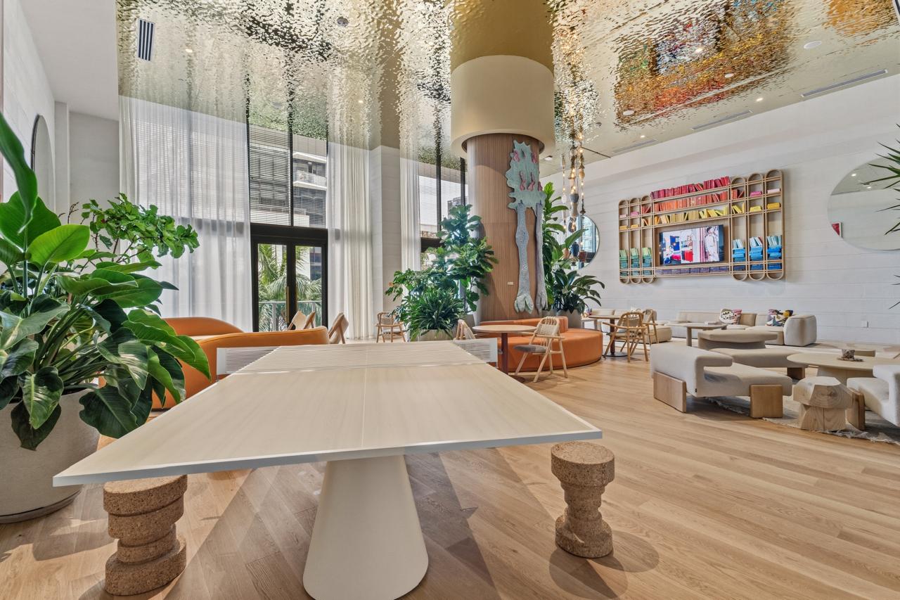 Lounge with ping pong table and library wall