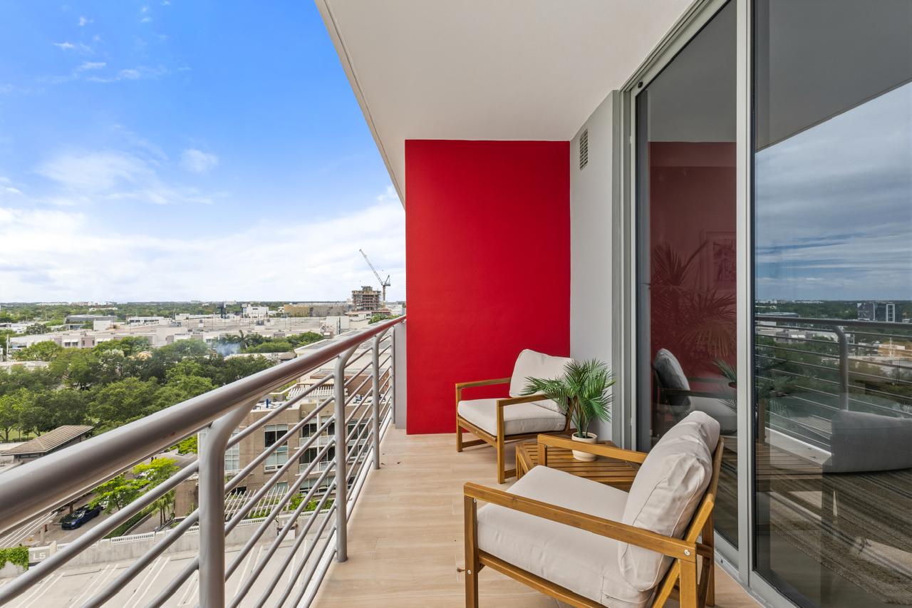 Balcony with two lounge chairs overlooking Midtown Miami