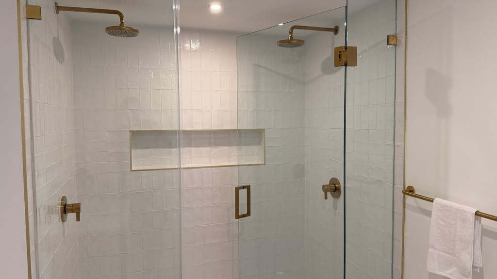Glass shower with brass fixtures