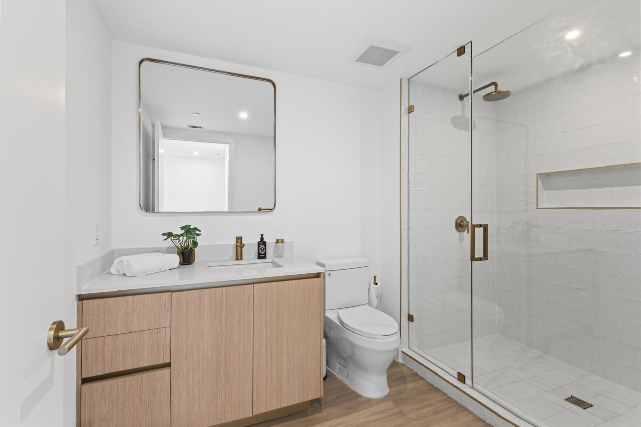 Bathroom with glass shower and brass fixtures