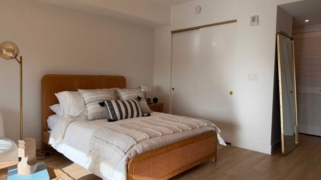 Bedroom with closet and full-length mirror