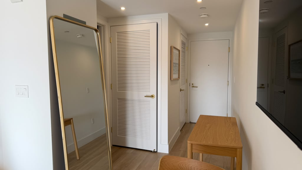 Entry hallway with full-length mirror and closets