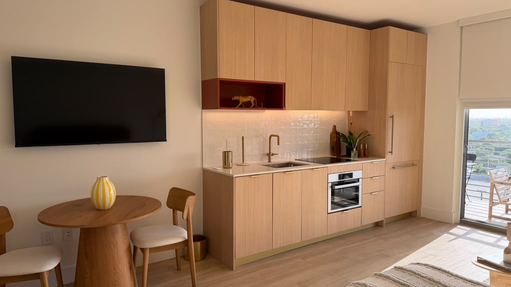 Kitchen with mounted TV and dining nook