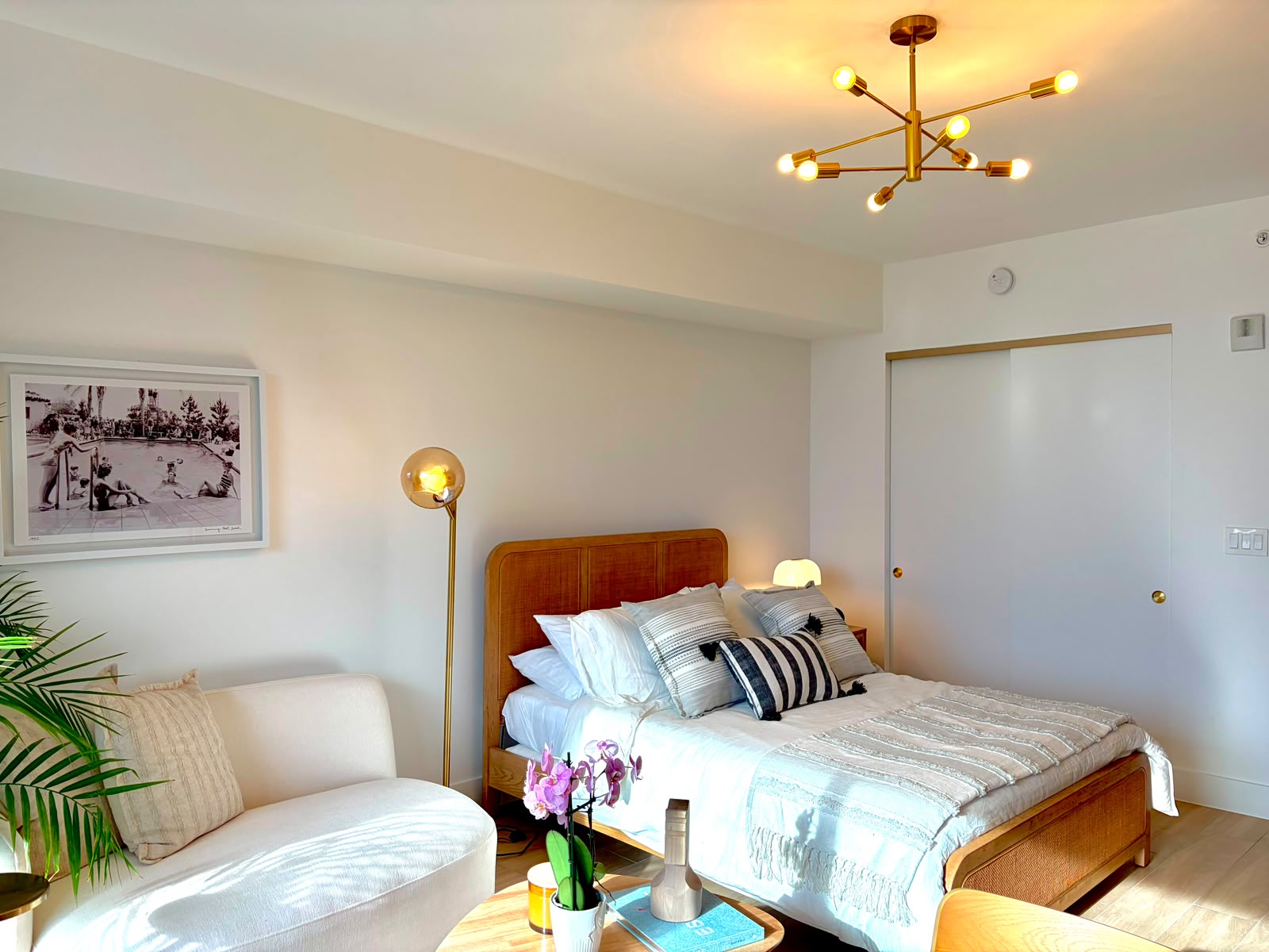 Bedroom with sofa and framed pool photography